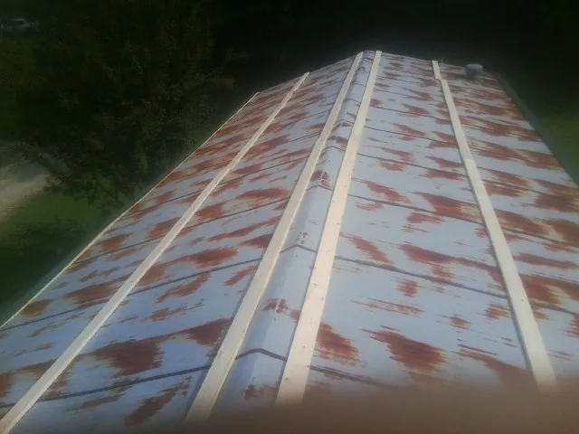 Rusted metal roof panels with new wood purlins before replacement — Storm Damage Roof Repair in Fork by Roofing Brothers
